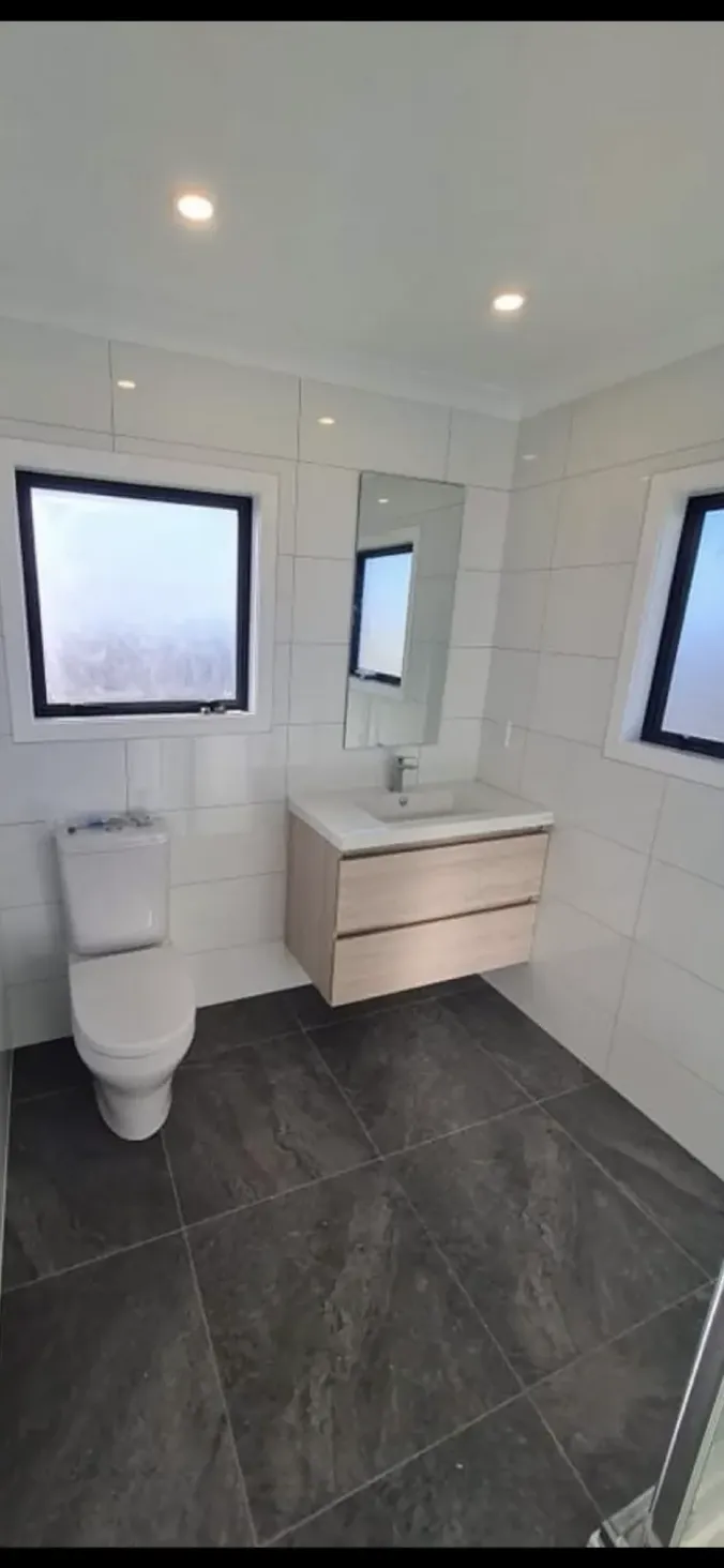 Modern bathroom renovation with timber vanity and open shower