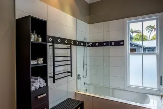 Modern bathroom with white subway tiles, bathtub and shower enclosure