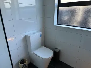 Contemporary bathroom with blue-grey wall tiles and minimalist design