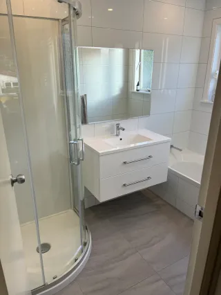 Double bathroom vanity with white countertop and framed mirror