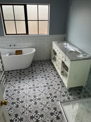 Bathroom renovation featuring patterned wall tiles and modern fixtures